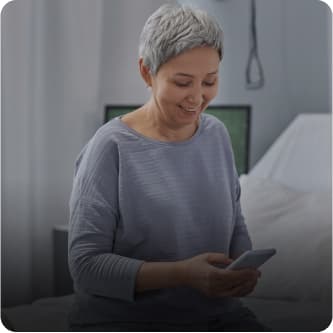 Woman reading electronic discharge instructions from her phone. 